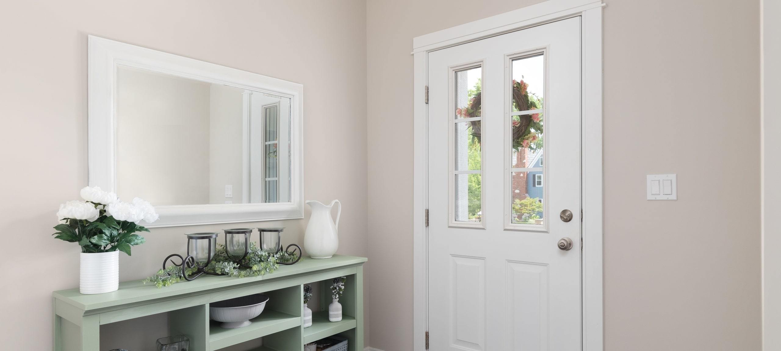 Entranceway to home with mirror and table, typical of Downtown Decatur